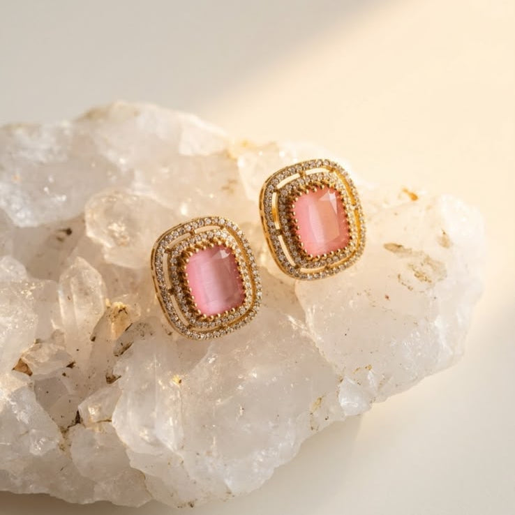 Elegant pink gemstone earrings with sparkling accents and a luxurious gold-tone finish.