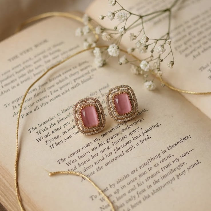 Elegant pink gemstone earrings with sparkling accents and a luxurious gold-tone finish.
